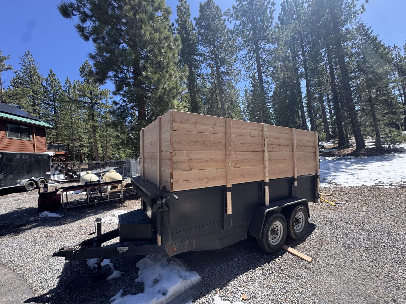 Wooden-sided dump trailer delivered to a Tahoe property for self-loading